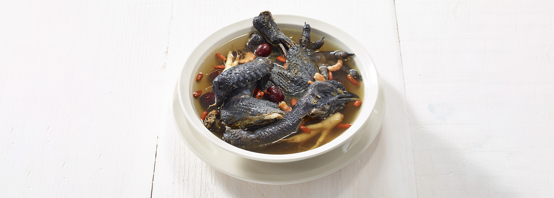 A bowl of ginseng and black chicken soup